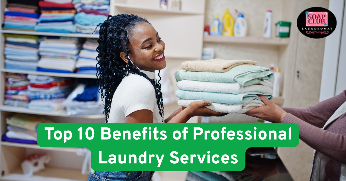 Smiling woman receiving folded towels from a laundromat staff member in a professional laundry setting.
